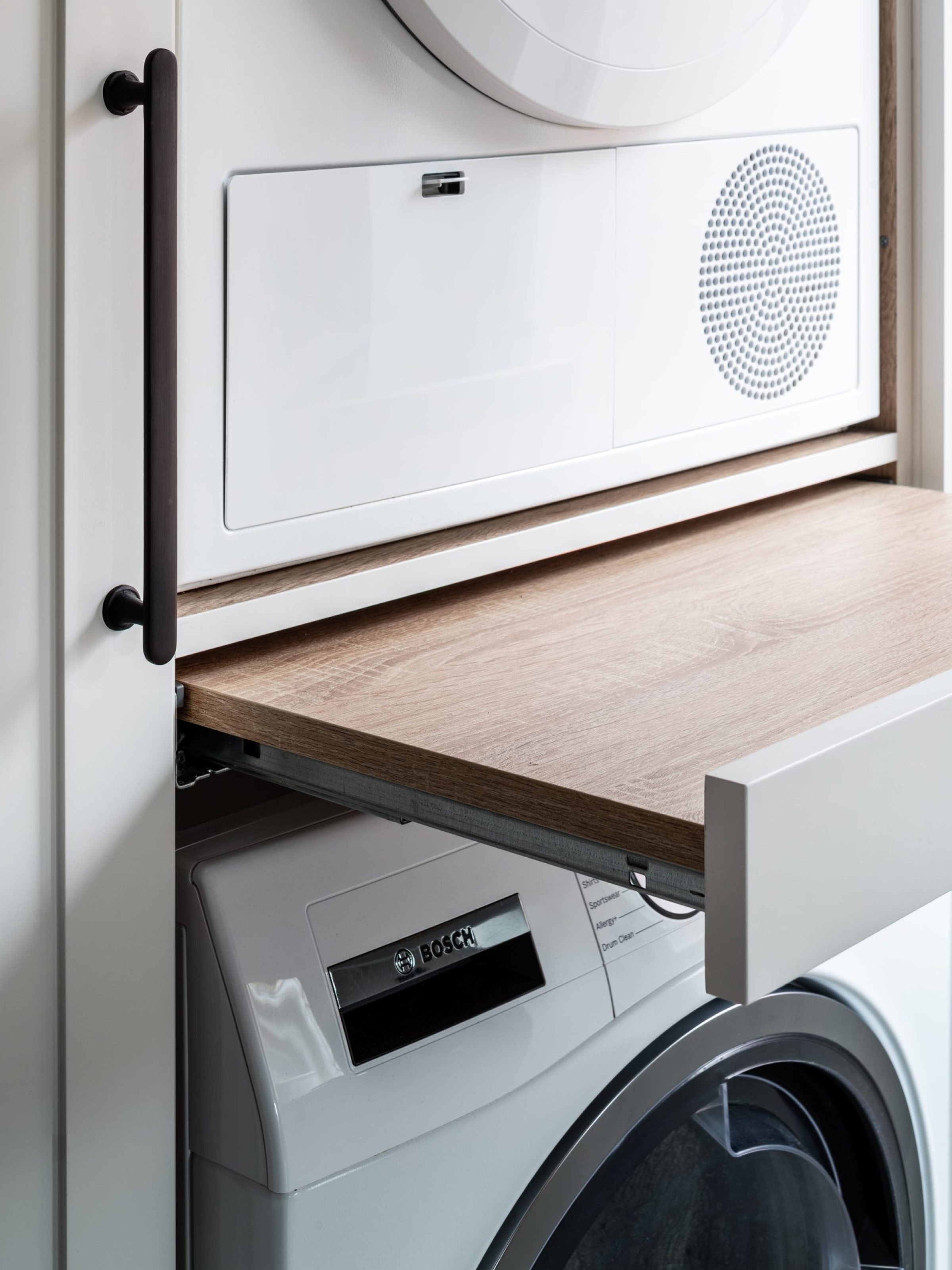 Bespoke cabinetry for stacked washer/drier with pull-out ledges